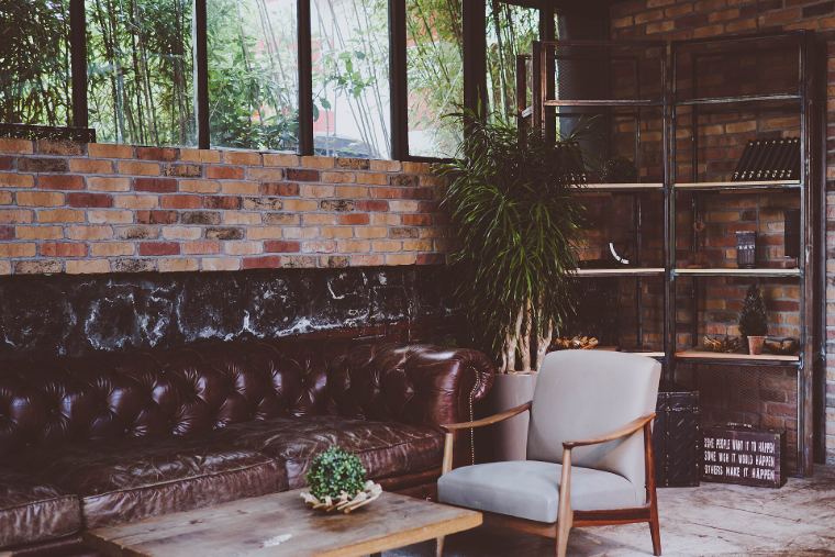 A living room with a leather sofa, an armchair and a low wooden table